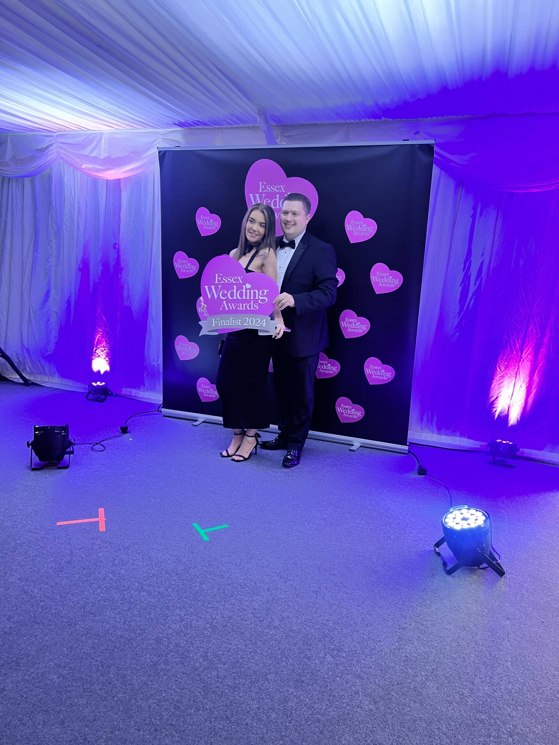 corporate-events with couple holding pink sign