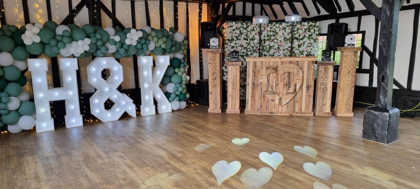 wedding reception dj booth with h and k letters